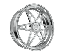 Chrome car wheel rim with star design.