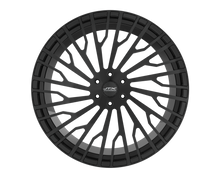 Black car wheel with intricate spoke design.