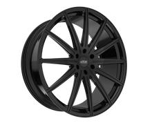 Black multi-spoke car wheel on black background.