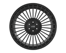 Black car wheel rim on black background.