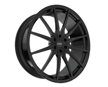 Black alloy wheel on black background.