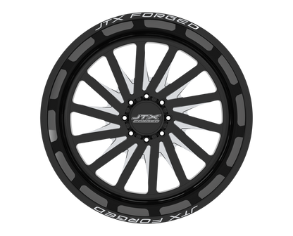 Black alloy wheel with JTX Forged branding.
