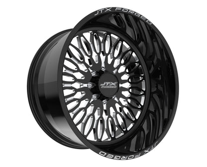 Black JTX Forged wheel with intricate design.